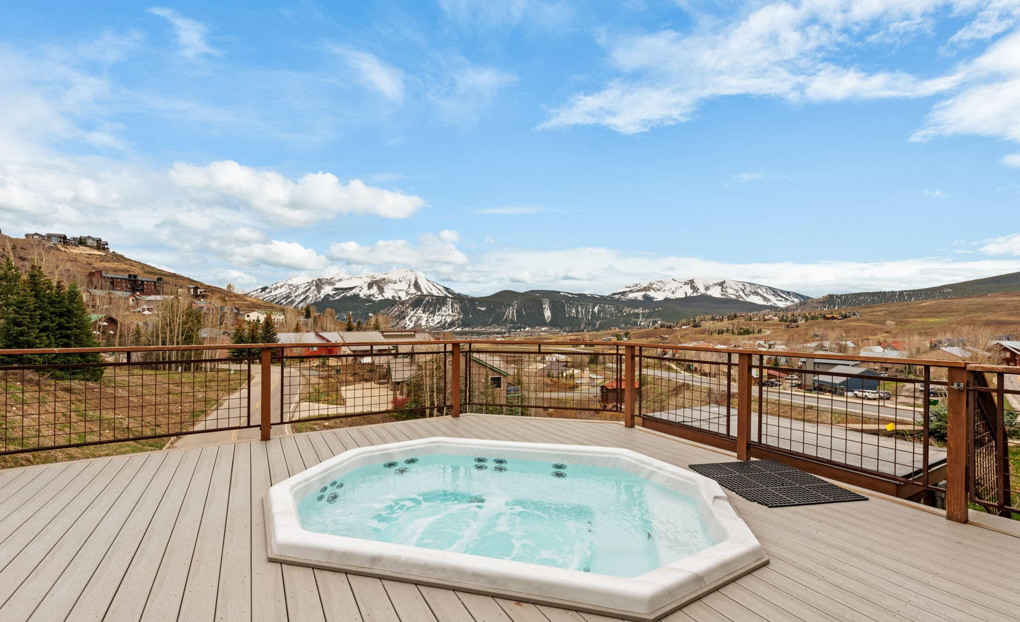 Shared outdoor hot tub at a Mt. Crested Butte condo overlooking a wide open valley and mountain views